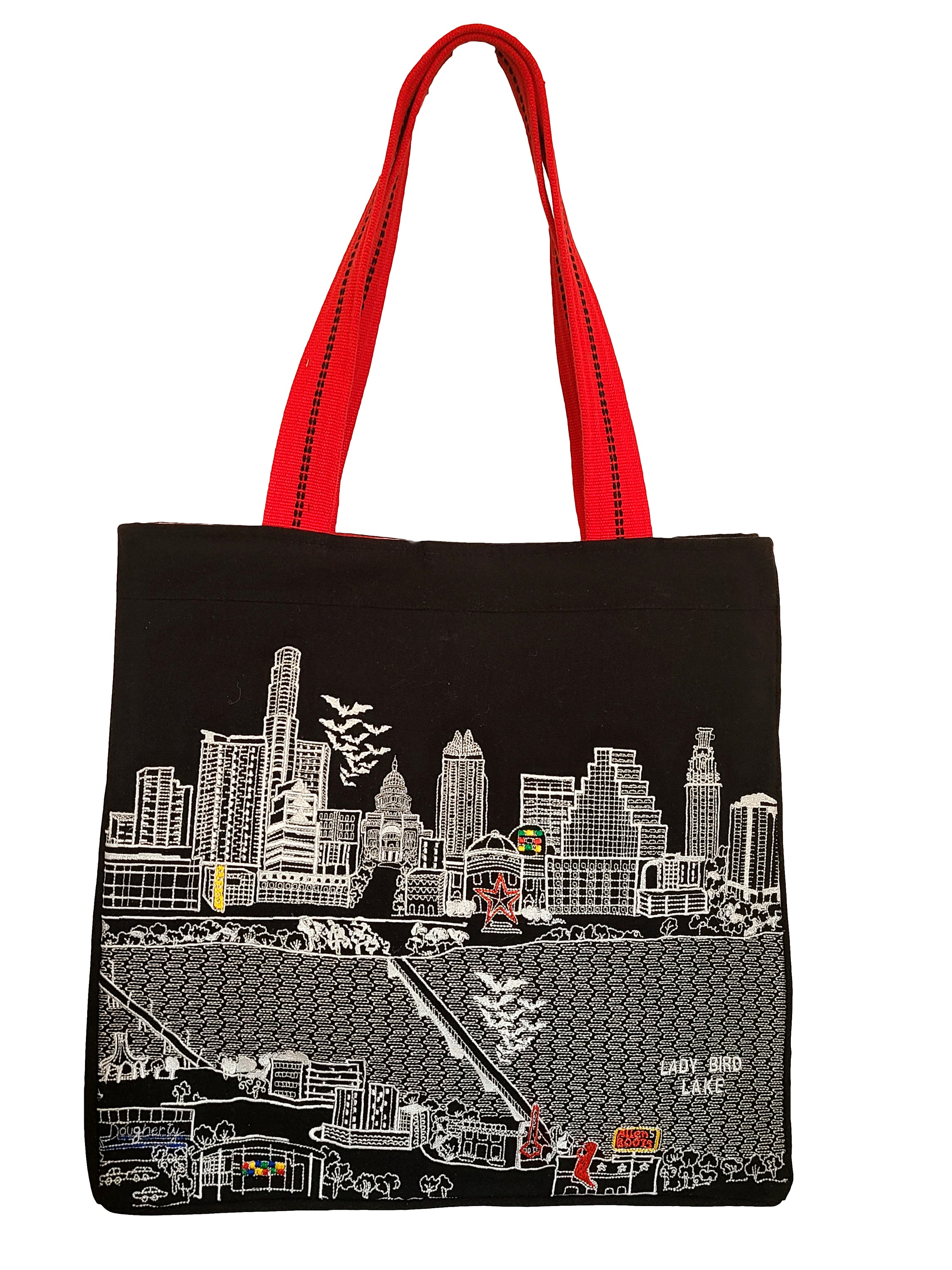 Austin Tote Bag featuring an embroidered skyline design, made of 100% cotton canvas with red waterproof lining and ribbed red straps.