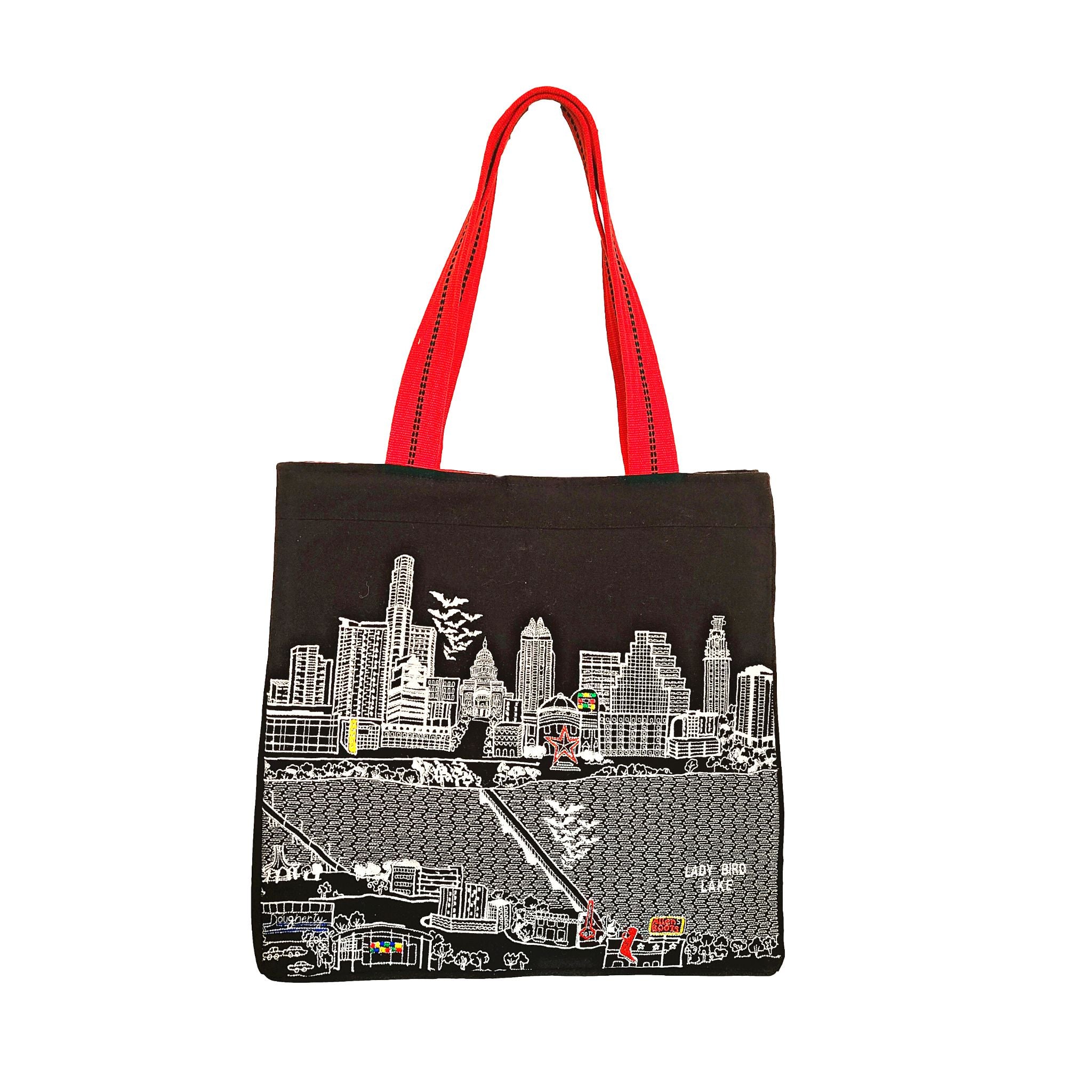 Austin Tote Bag featuring an embroidered skyline design, made of 100% cotton canvas with red waterproof lining and ribbed red straps.