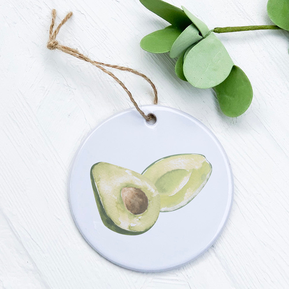 A beautifully crafted porcelain avocado ornament with vibrant colors and a glossy finish, perfect for home decor or gifting.