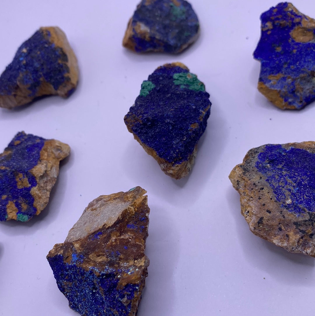 A collection of vibrant blue Azurite chunks showcasing their unique textures and colors, perfect for emotional balance and inner strength.