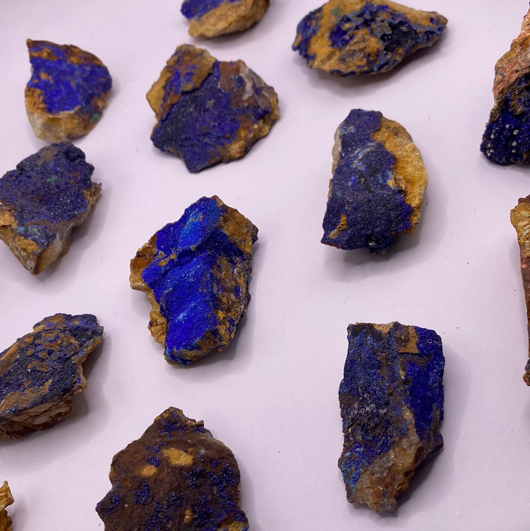 A collection of vibrant blue Azurite chunks showcasing their unique textures and colors, perfect for emotional balance and inner strength.