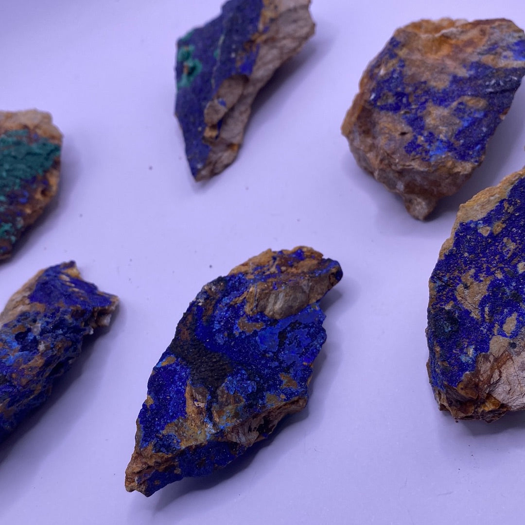 A collection of vibrant blue Azurite chunks showcasing their unique textures and colors, perfect for emotional balance and inner strength.