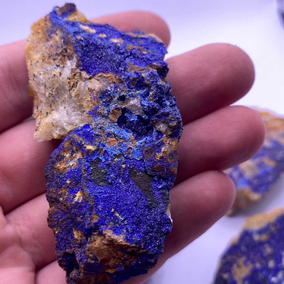 A collection of vibrant blue Azurite chunks showcasing their unique textures and colors, perfect for emotional balance and inner strength.