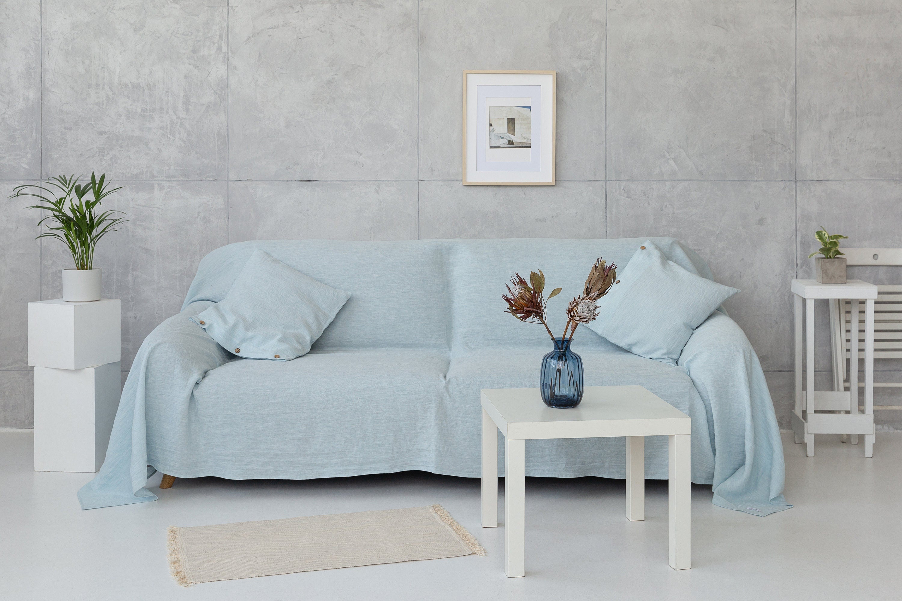 A stylish Baby Blue linen couch cover draped elegantly over a sofa, showcasing its soft texture and beautiful color.