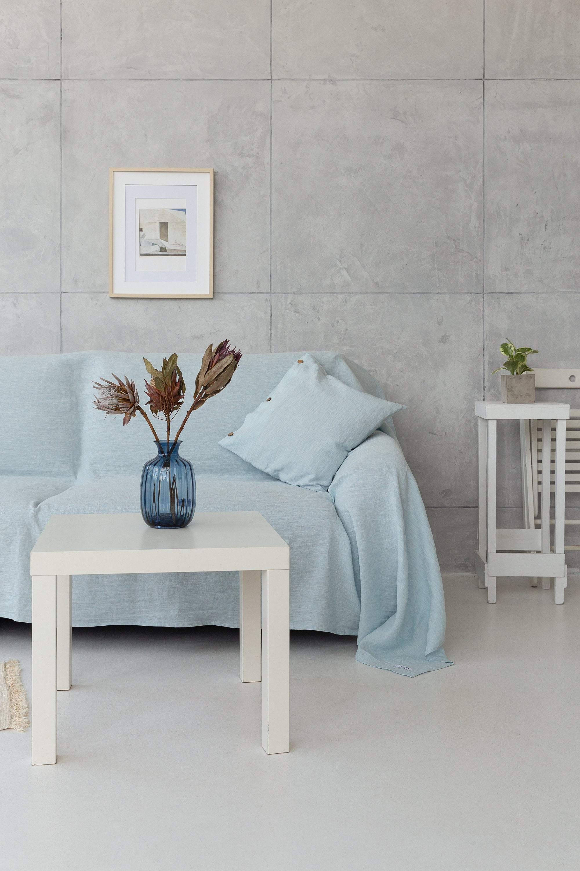 A stylish Baby Blue linen couch cover draped elegantly over a sofa, showcasing its soft texture and beautiful color.