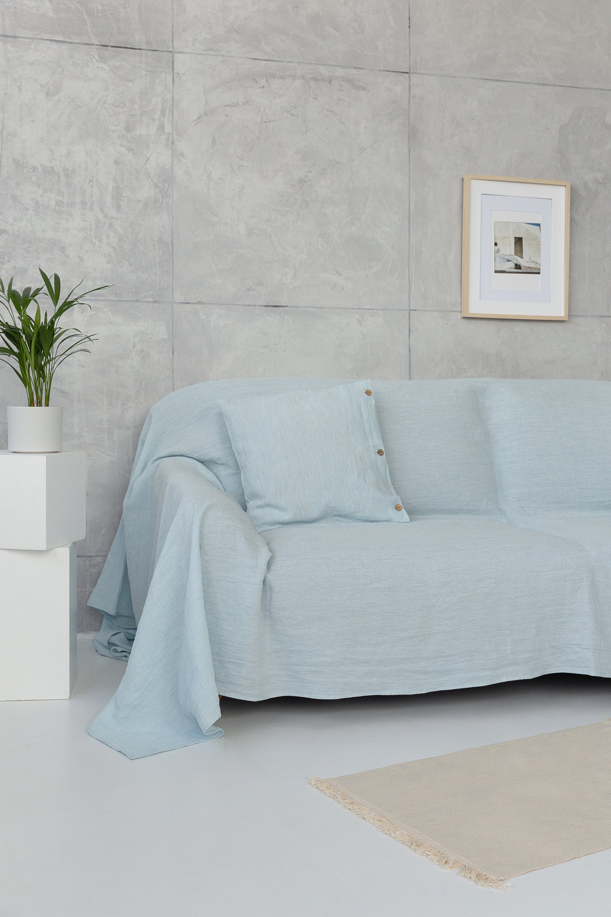 A stylish Baby Blue linen couch cover draped elegantly over a sofa, showcasing its soft texture and beautiful color.