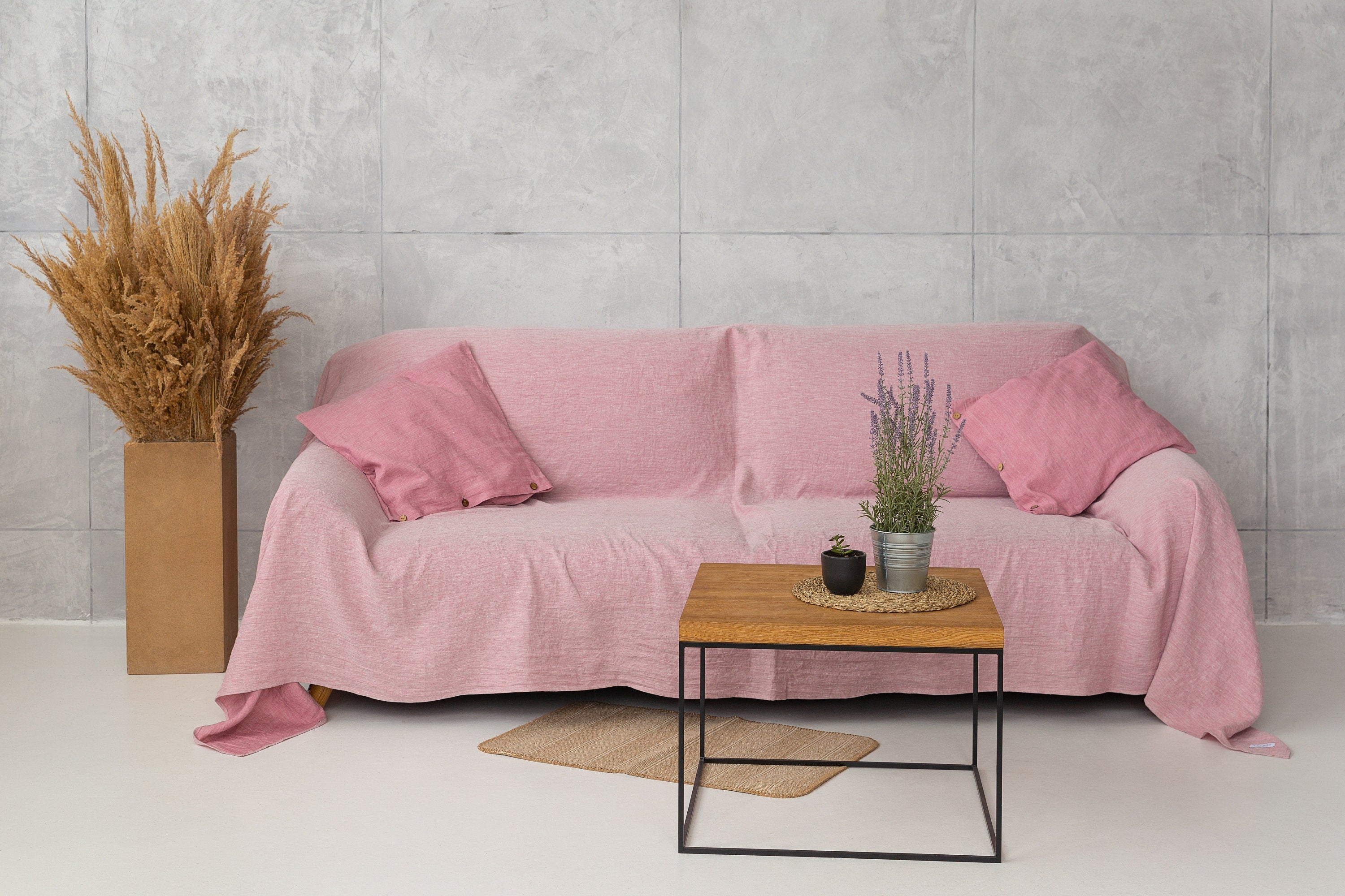 A stylish Baby Blue linen couch cover draped elegantly over a sofa, showcasing its soft texture and beautiful color.