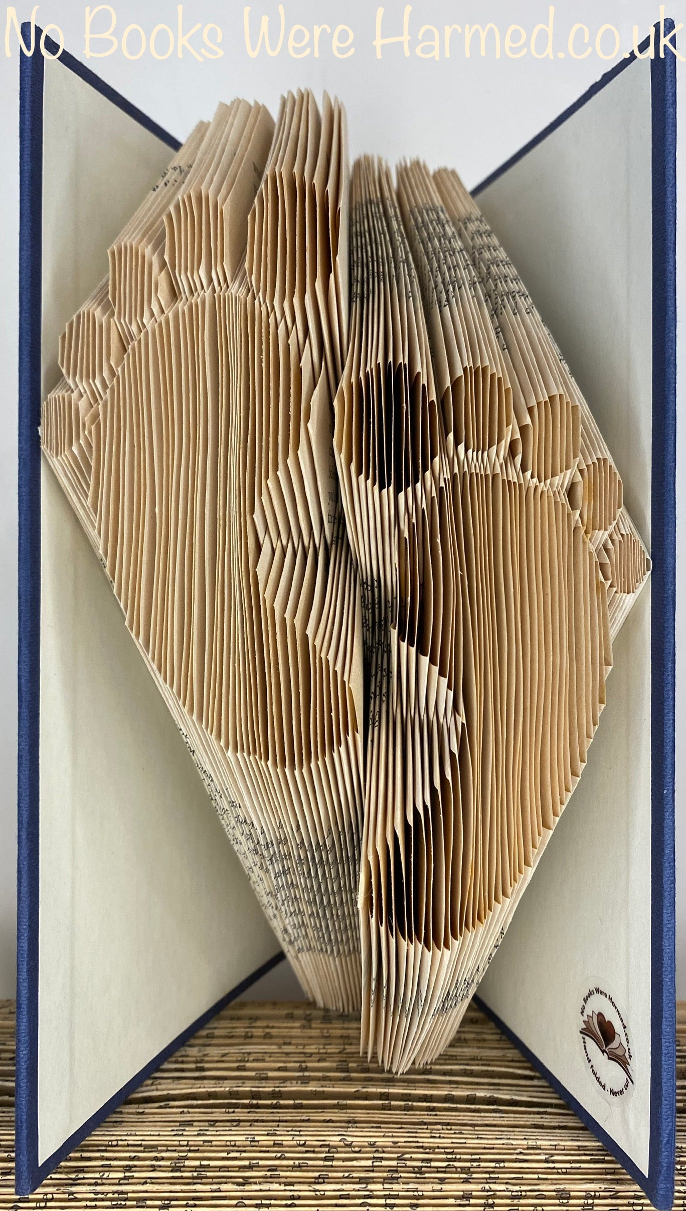 Hand-folded Baby Feet art made from vintage books, showcasing unique foot prints and foot steps design.