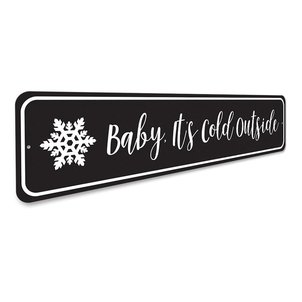 A decorative Baby It's Cold Outside Sign made of high-quality aluminum, featuring festive colors and a charming design, perfect for Christmas decorations.