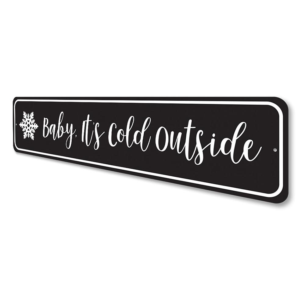 A decorative Baby It's Cold Outside Sign made of high-quality aluminum, featuring festive colors and a charming design, perfect for Christmas decorations.