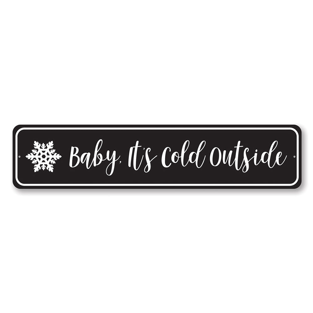 A decorative Baby It's Cold Outside Sign made of high-quality aluminum, featuring festive colors and a charming design, perfect for Christmas decorations.