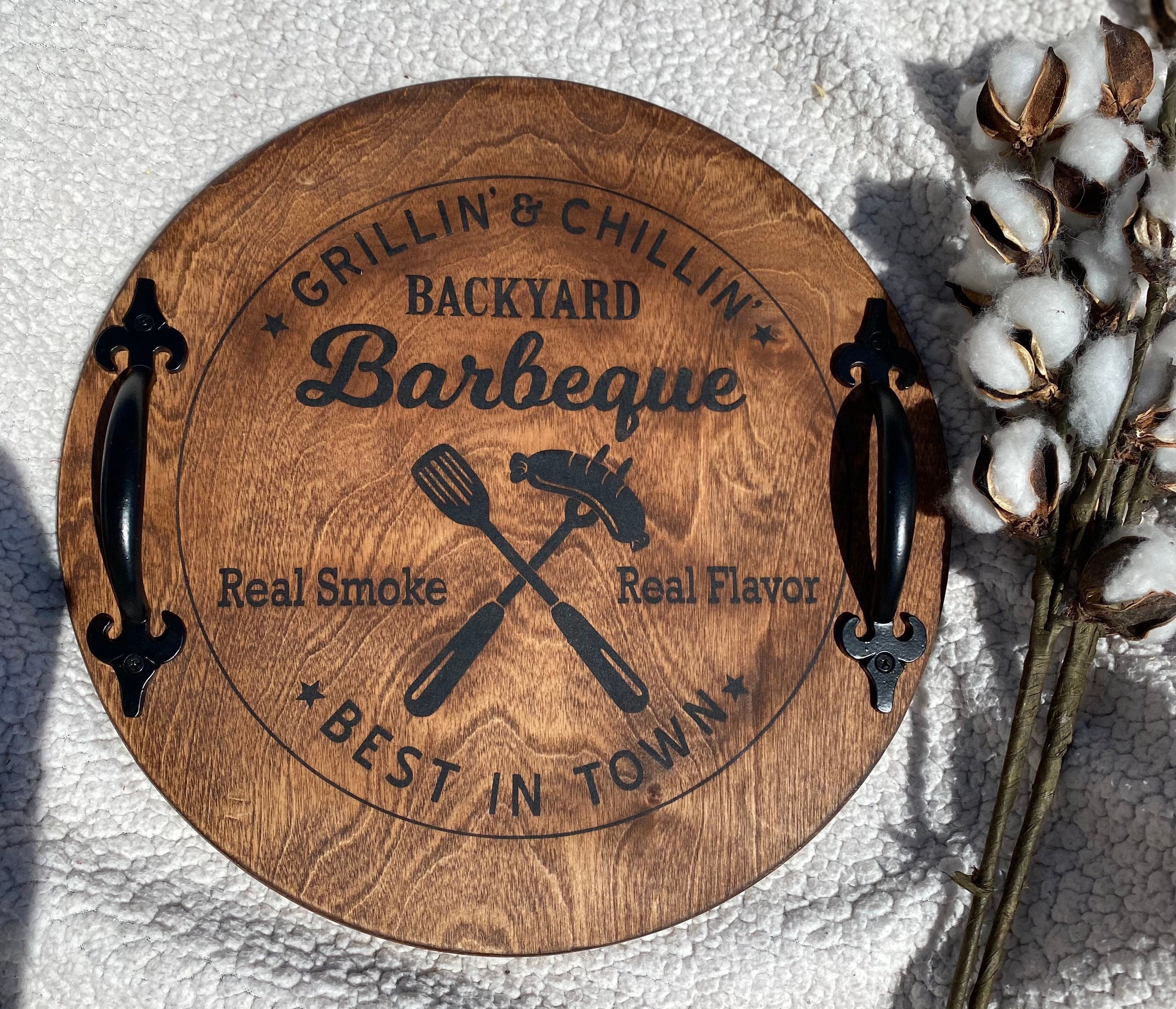 Handmade Backyard BBQ Wooden Serving Tray with dark chestnut stain and black metal handles, showcasing unique wood grain patterns.