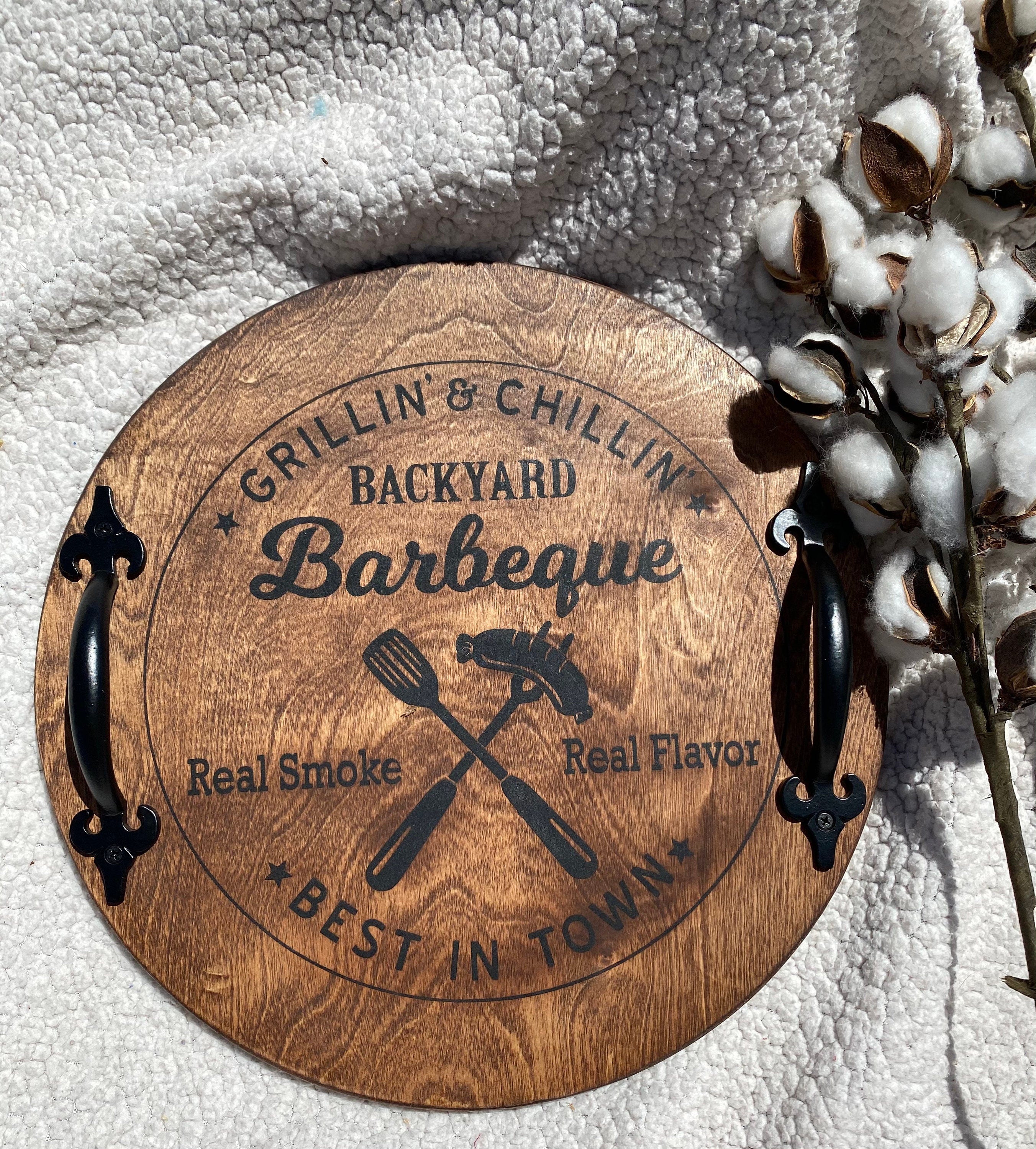 Handmade Backyard BBQ Wooden Serving Tray with dark chestnut stain and black metal handles, showcasing unique wood grain patterns.