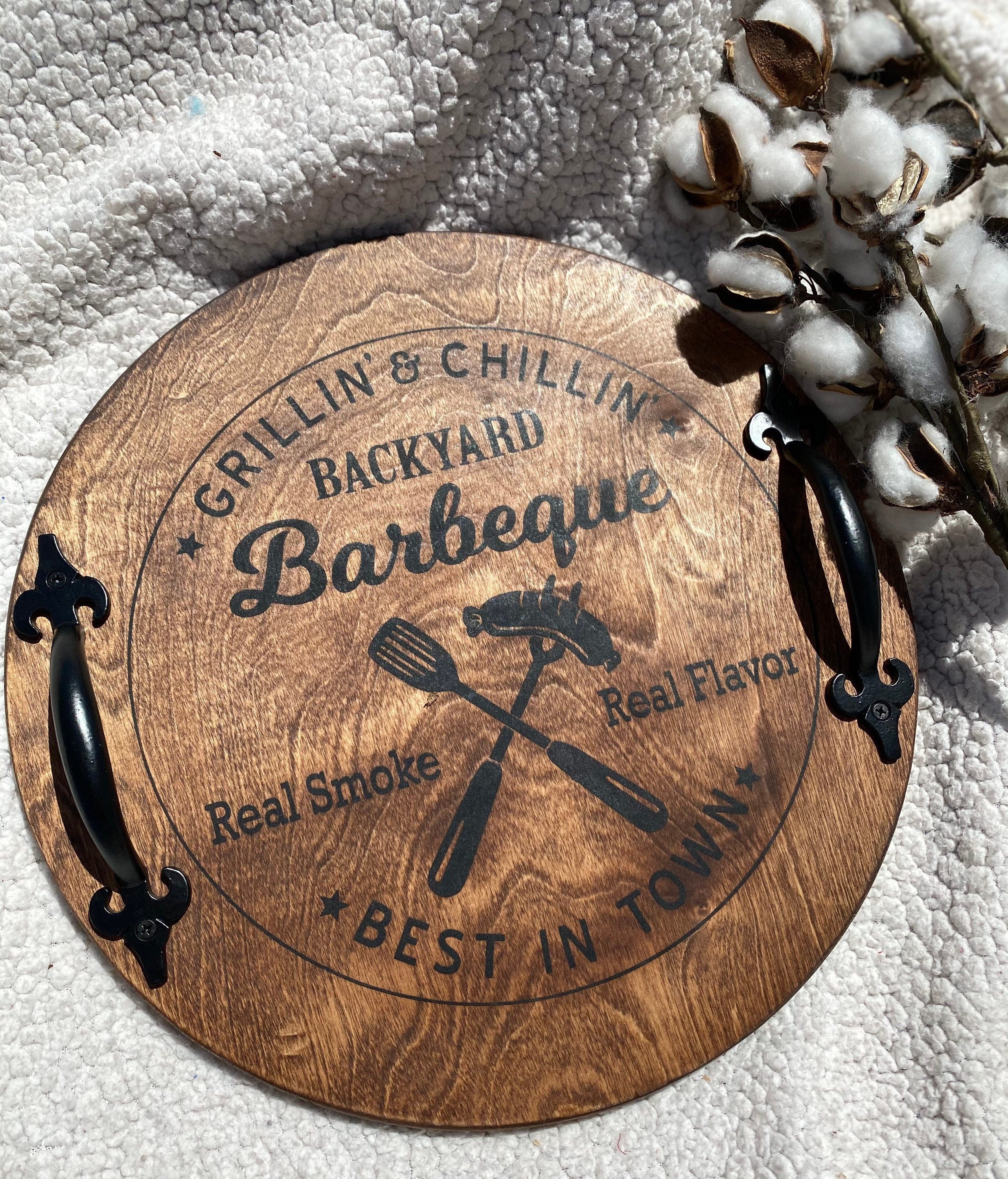 Handmade Backyard BBQ Wooden Serving Tray with dark chestnut stain and black metal handles, showcasing unique wood grain patterns.