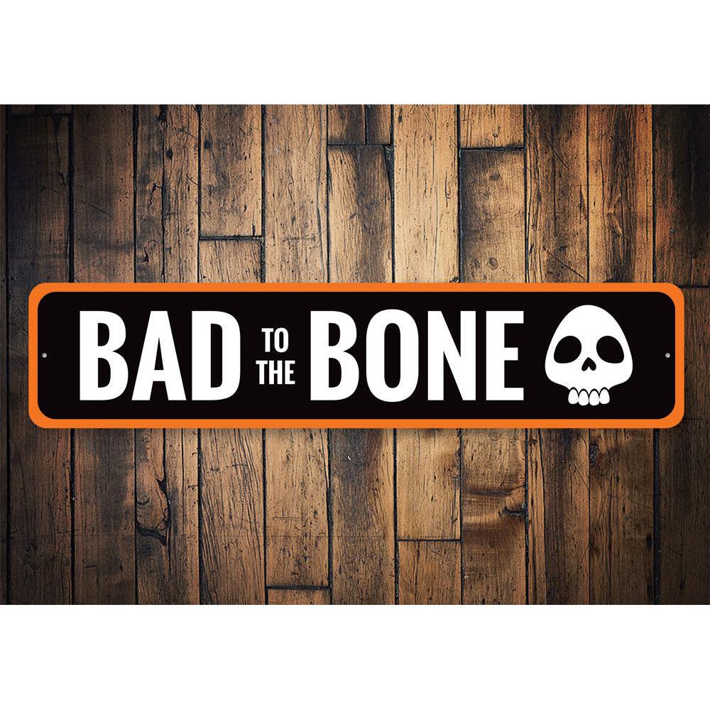 Bad to the Bone Sign featuring spooky lettering on a high-quality aluminum background, perfect for Halloween decor.