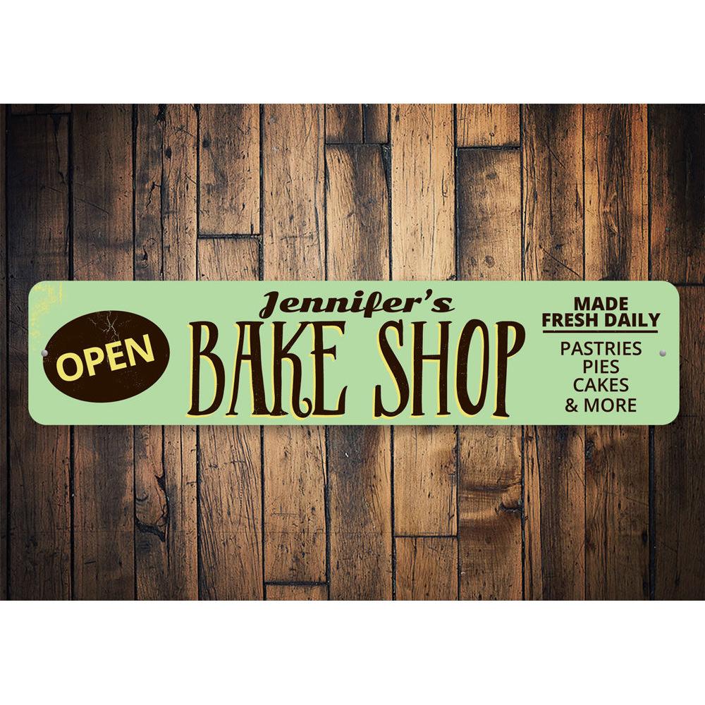 A decorative Bake Shop Open Sign made of high-quality aluminum, featuring customizable text and pre-drilled holes for easy mounting.