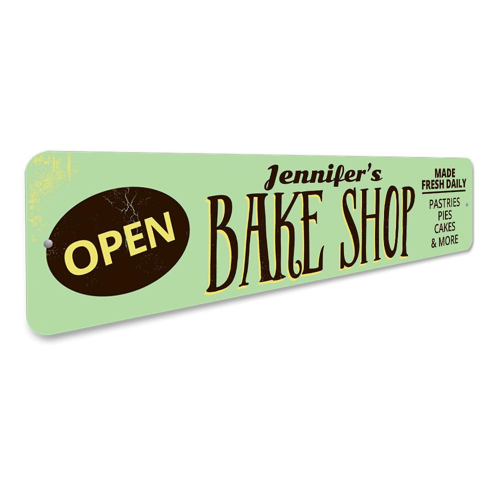 A decorative Bake Shop Open Sign made of high-quality aluminum, featuring customizable text and pre-drilled holes for easy mounting.