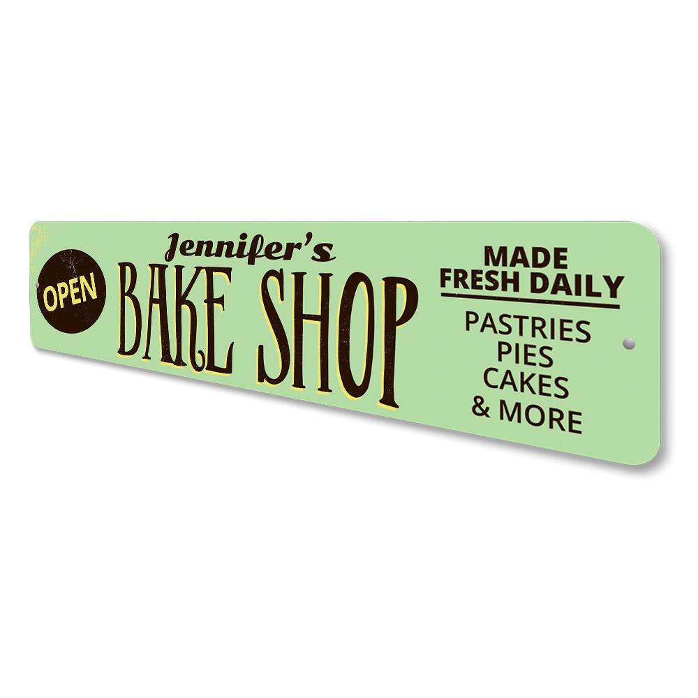 A decorative Bake Shop Open Sign made of high-quality aluminum, featuring customizable text and pre-drilled holes for easy mounting.