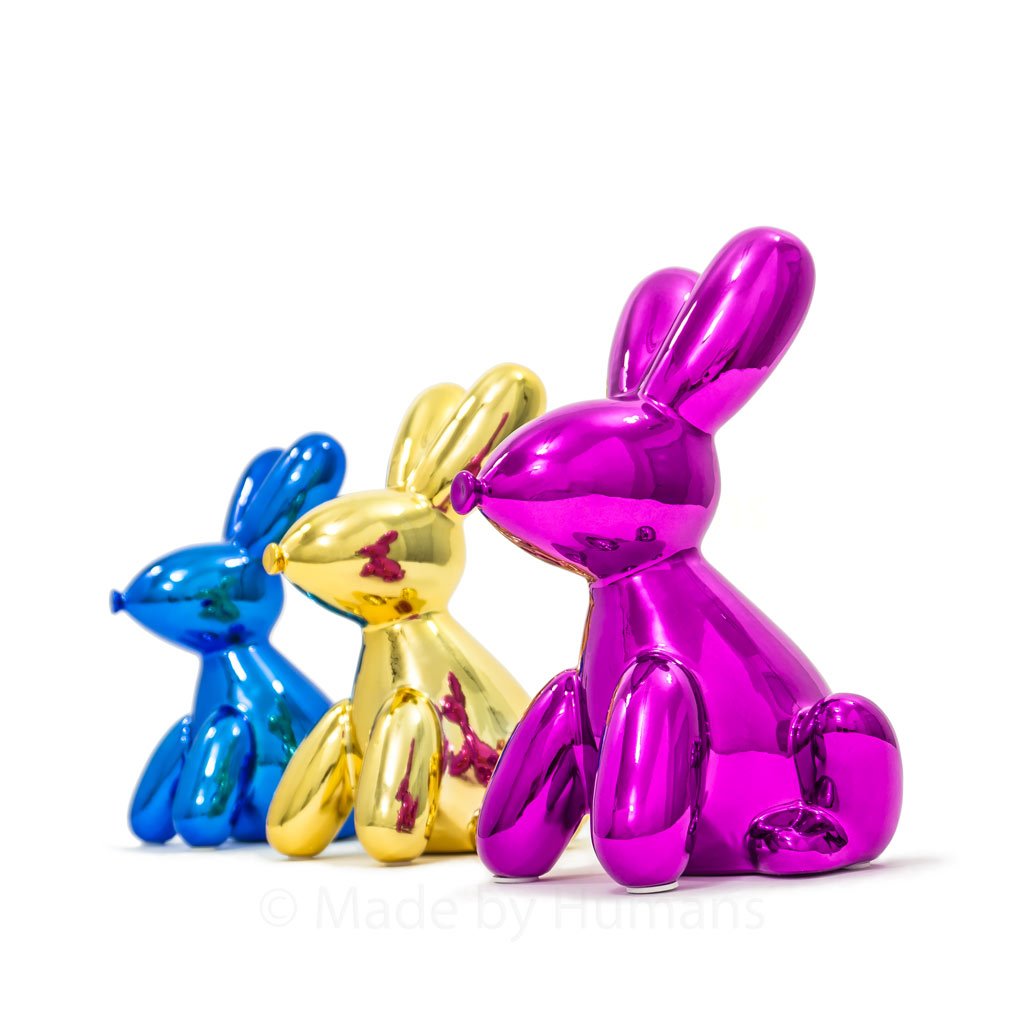 A glossy ceramic balloon bunny money bank in vibrant colors, featuring pink ears and a cheerful smile, perfect for saving coins.