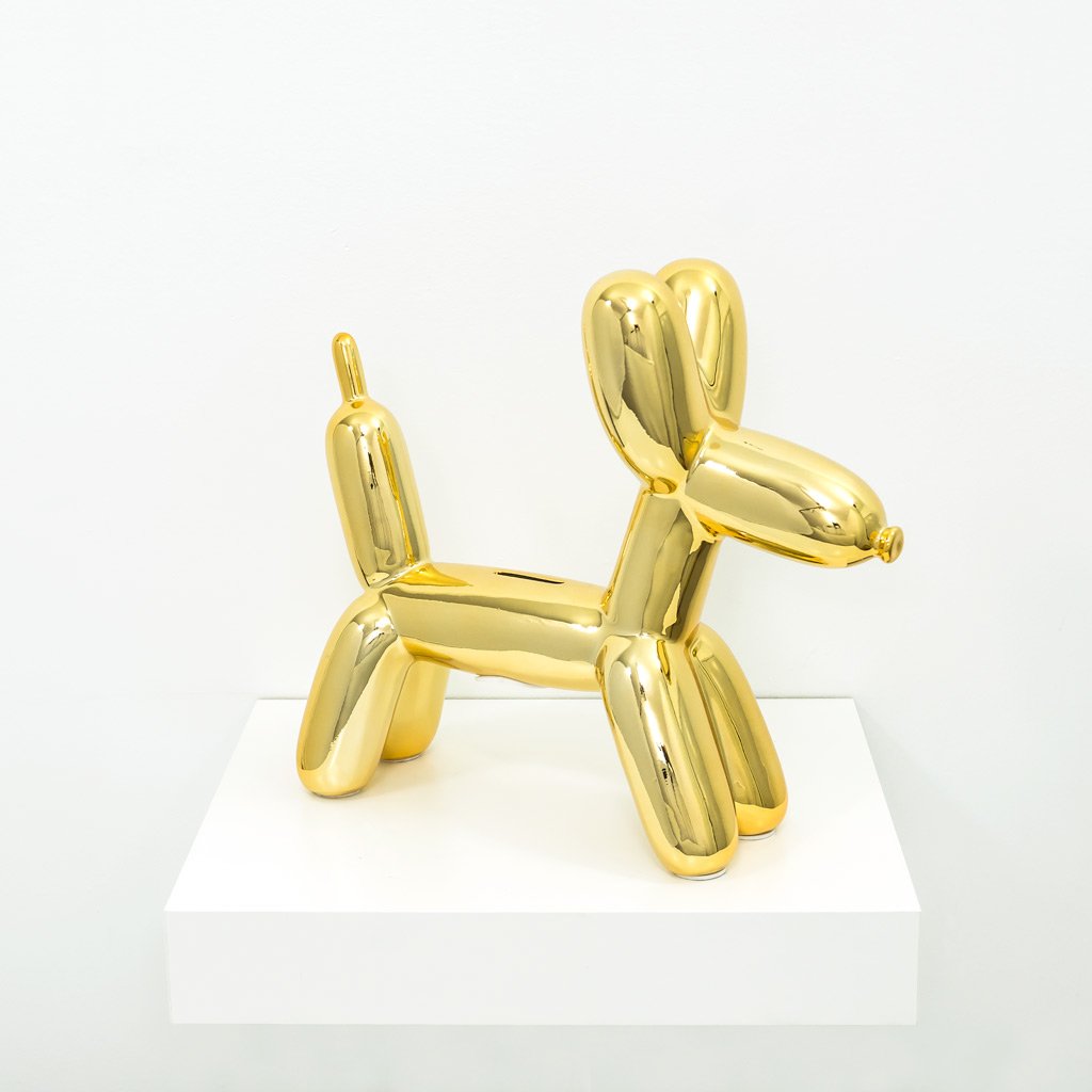 A glossy balloon dog money bank in vibrant colors, showcasing its playful design and high-gloss ceramic finish.