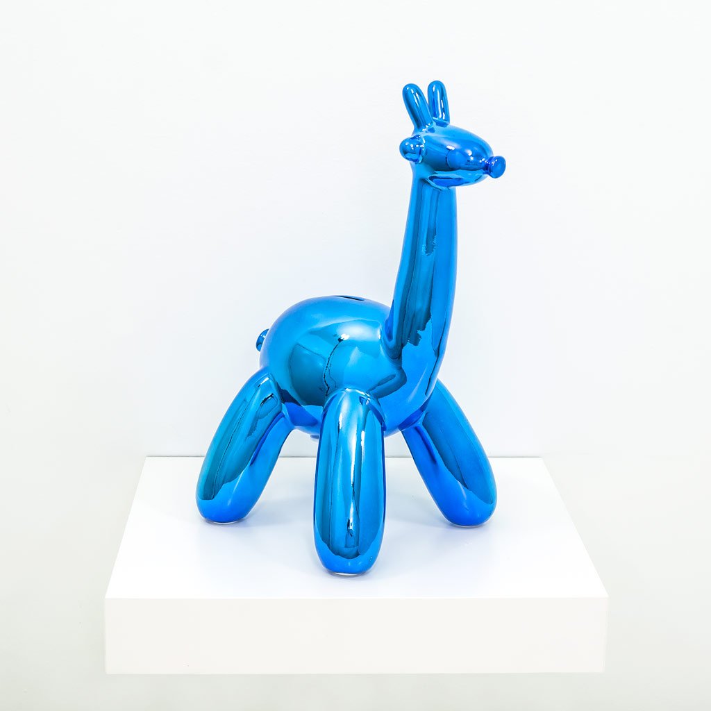 A stylish Balloon Money Bank shaped like a giraffe, featuring a glossy metallic finish in blue, gold, and pink colors, perfect for saving coins.