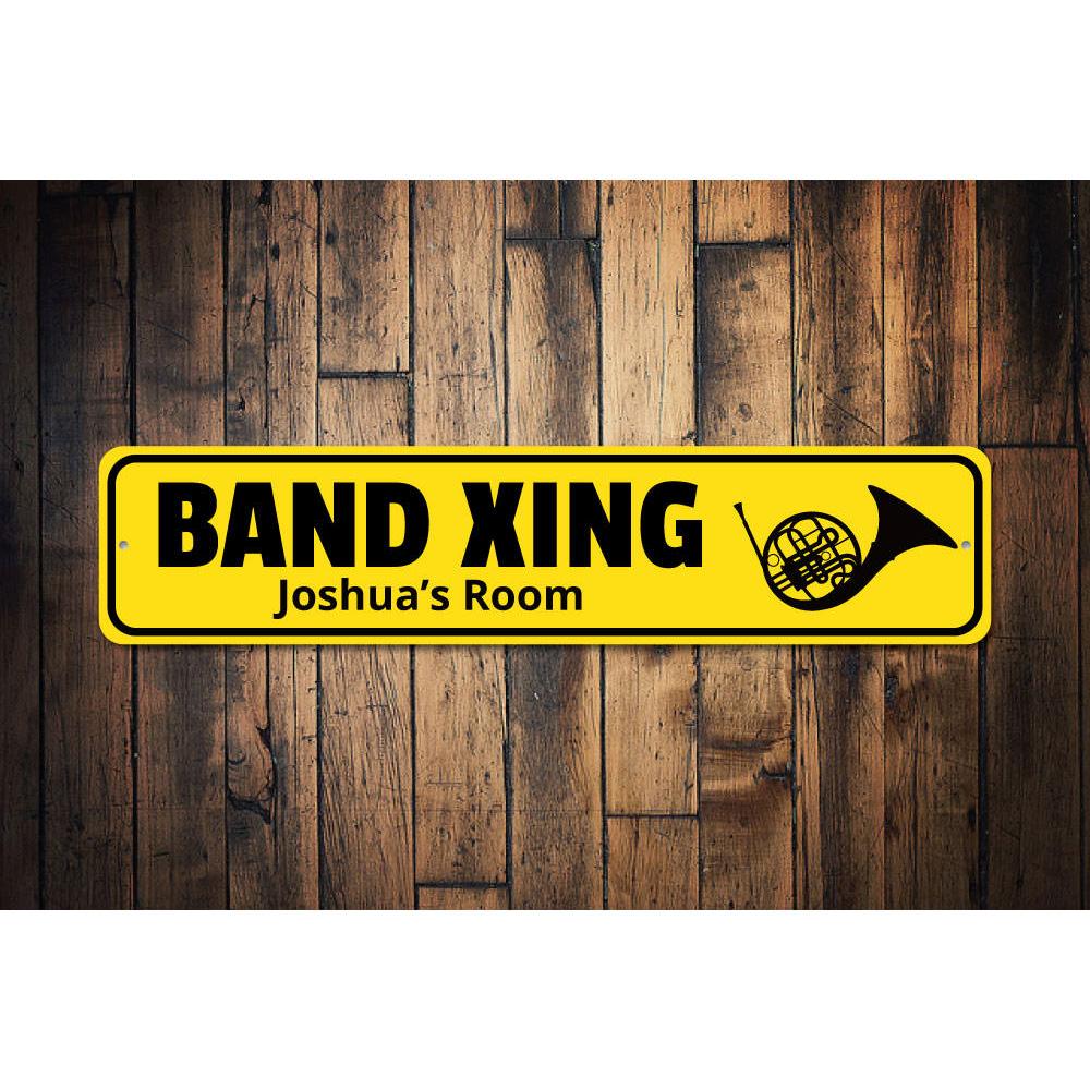 A customizable Band Crossing Sign made of high-quality aluminum, featuring pre-drilled holes for easy mounting, showcasing a unique design.