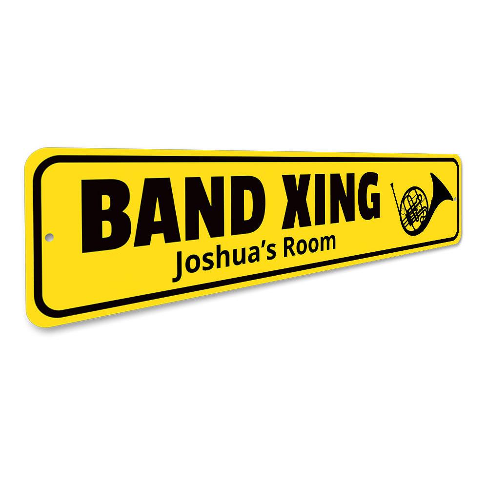 A customizable Band Crossing Sign made of high-quality aluminum, featuring pre-drilled holes for easy mounting, showcasing a unique design.