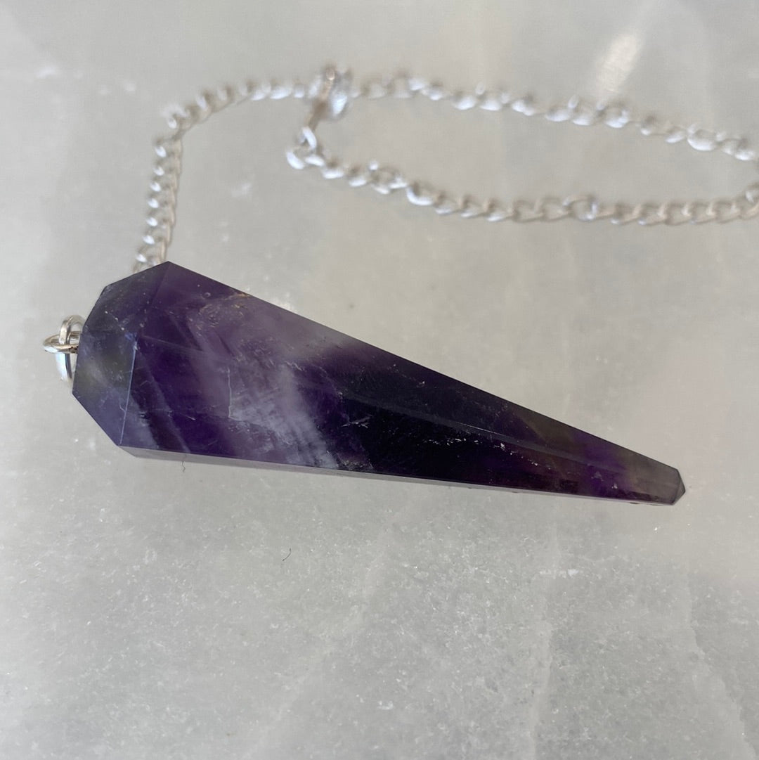 A beautiful Banded Amethyst Pendulum showcasing unique purple hues, perfect for spiritual practices and collections.