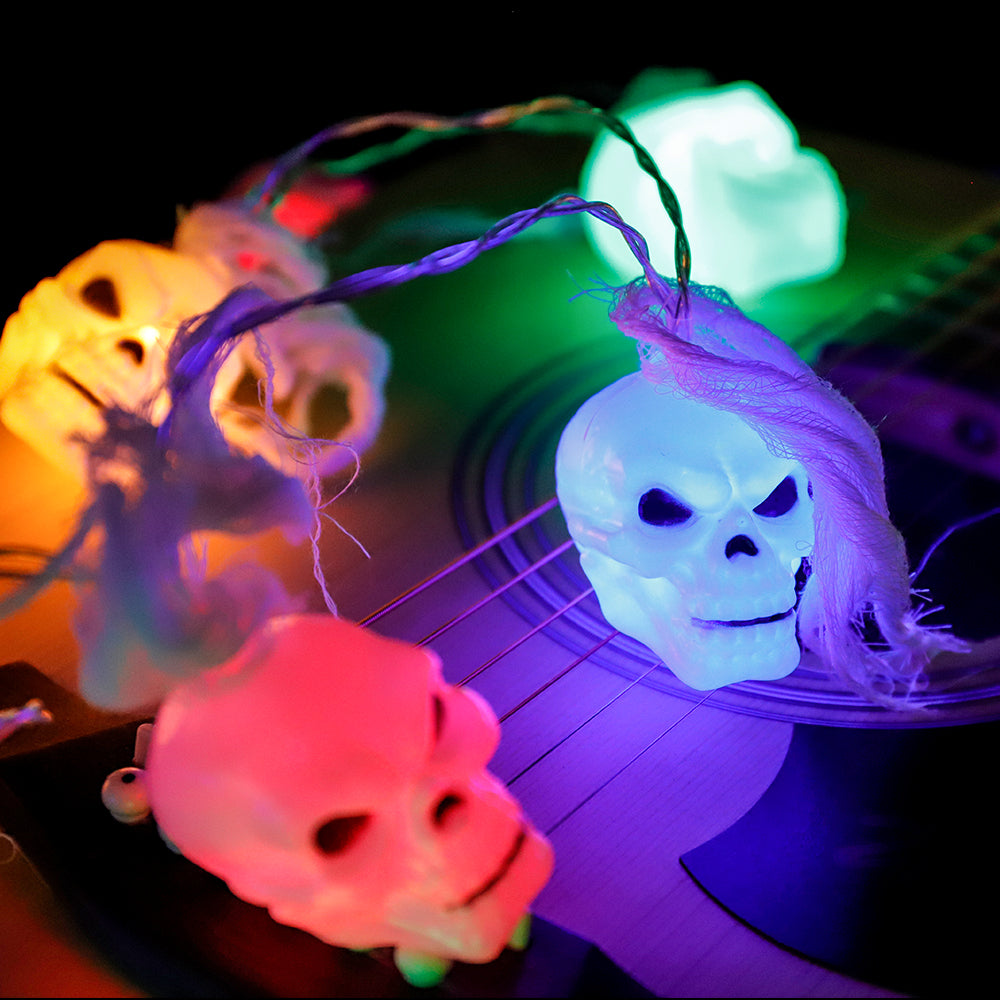 Battery Powered Halloween Ghost Skull Lights featuring 12 LED skulls on a 6-foot string, perfect for spooky decorations.