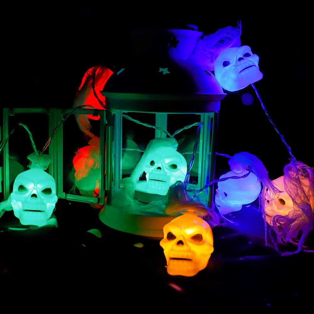 Battery Powered Halloween Ghost Skull Lights featuring 12 LED skulls on a 6-foot string, perfect for spooky decorations.