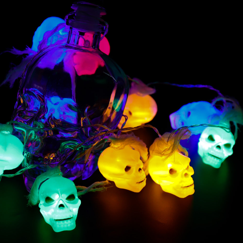 Battery Powered Halloween Ghost Skull Lights featuring 12 LED skulls on a 6-foot string, perfect for spooky decorations.