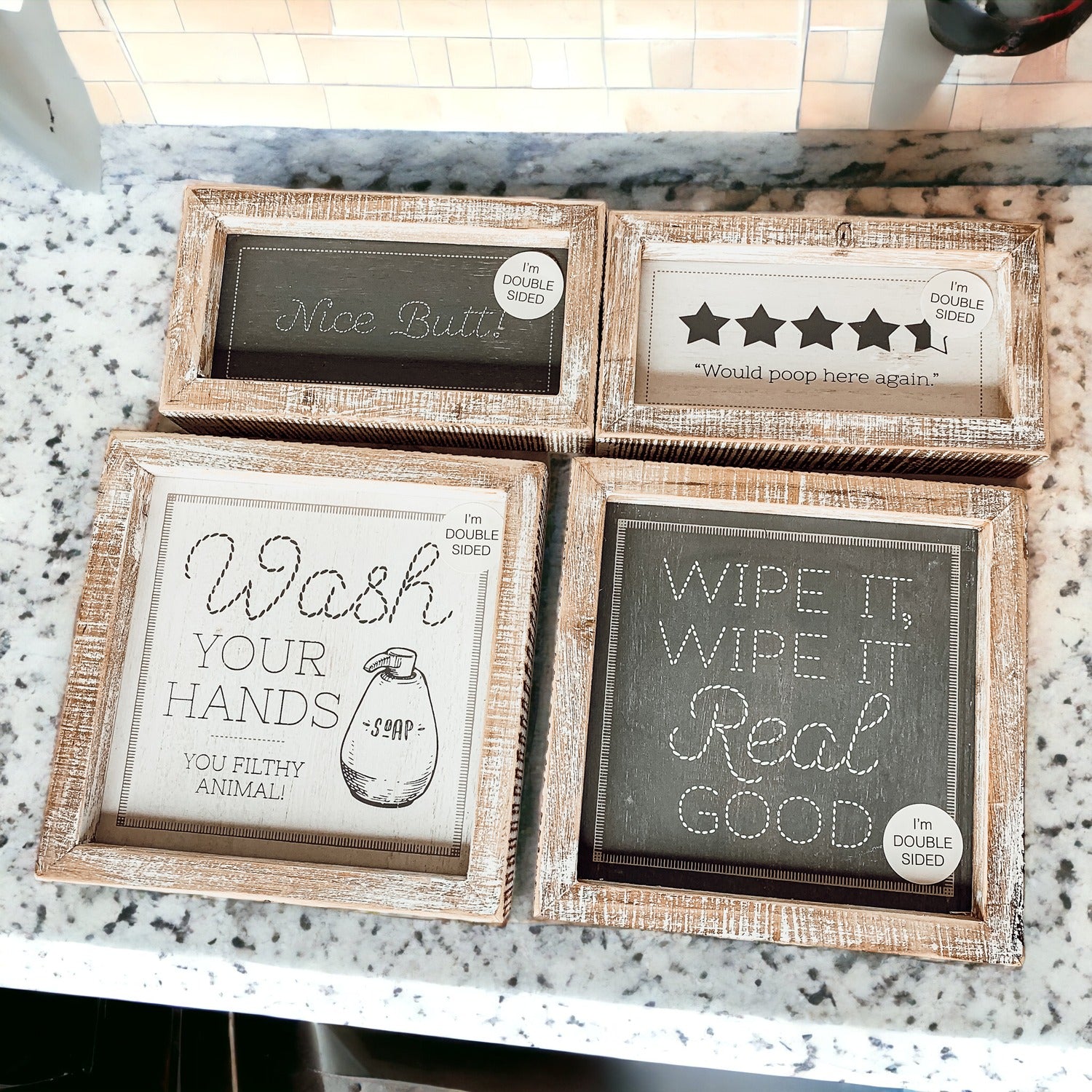 Double-sided bathroom sign featuring humorous quotes, framed in a thick wooden frame, suitable for freestanding or wall display.