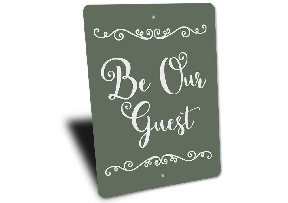 A decorative Be Our Guest Sign made of high-quality aluminum, featuring a welcoming design suitable for indoor and outdoor use.