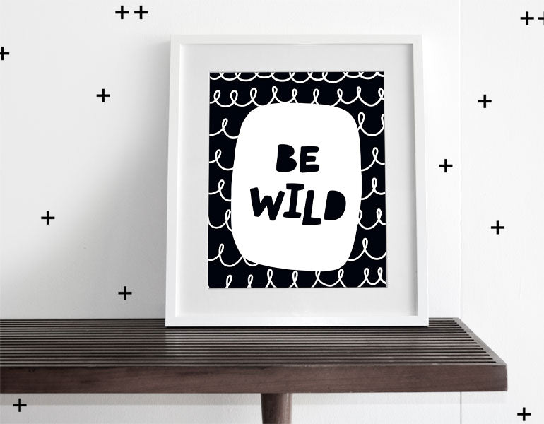 Be Wild wall art featuring modern design for nursery decor, framed with a white matte.