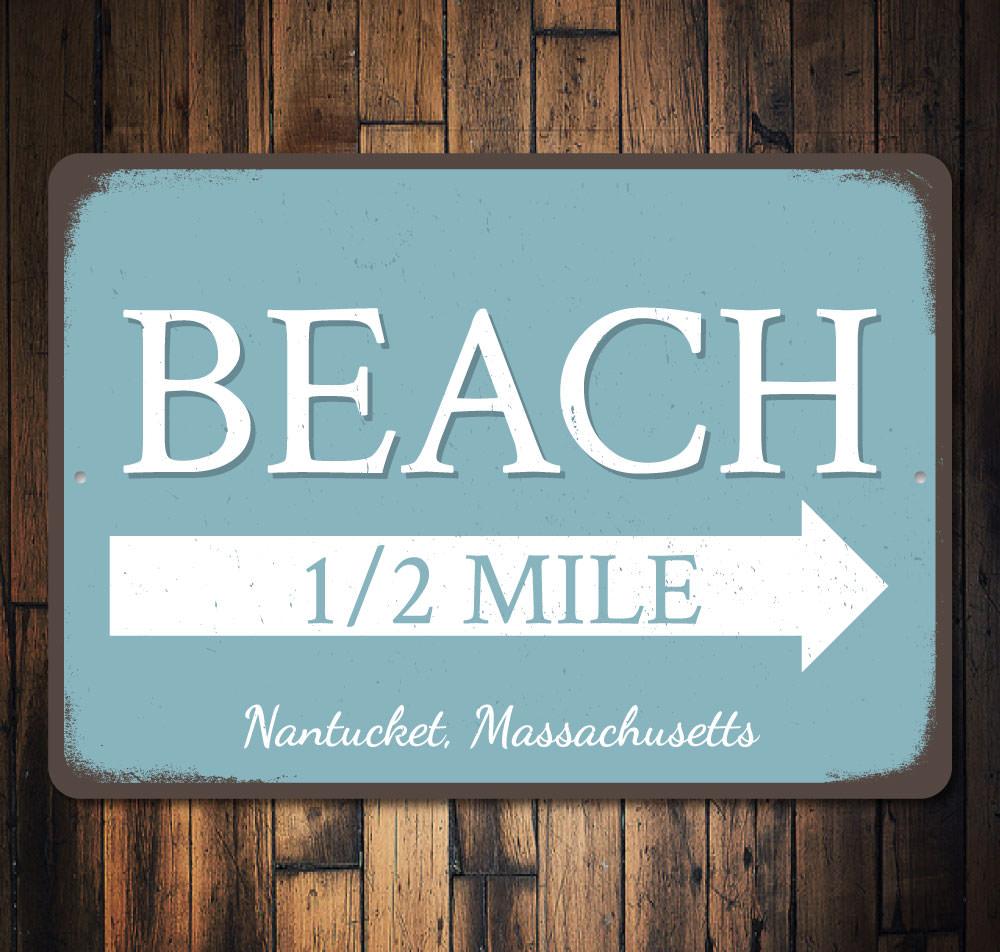 Beach Half Mile Arrow Sign made of durable aluminum, featuring a coastal design perfect for beach houses and outdoor decor.