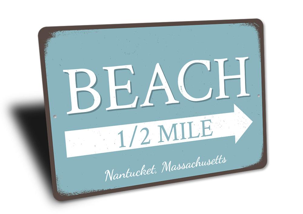 Beach Half Mile Arrow Sign made of durable aluminum, featuring a coastal design perfect for beach houses and outdoor decor.