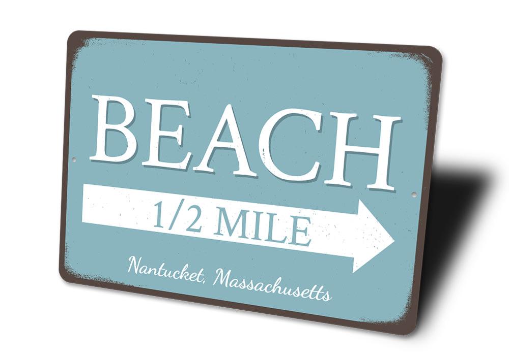 Beach Half Mile Arrow Sign made of durable aluminum, featuring a coastal design perfect for beach houses and outdoor decor.