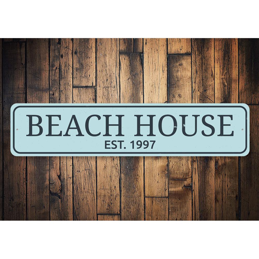 A personalized Beach House Established Date Sign made of high-quality aluminum, featuring custom text and a coastal design, suitable for indoor and outdoor use.