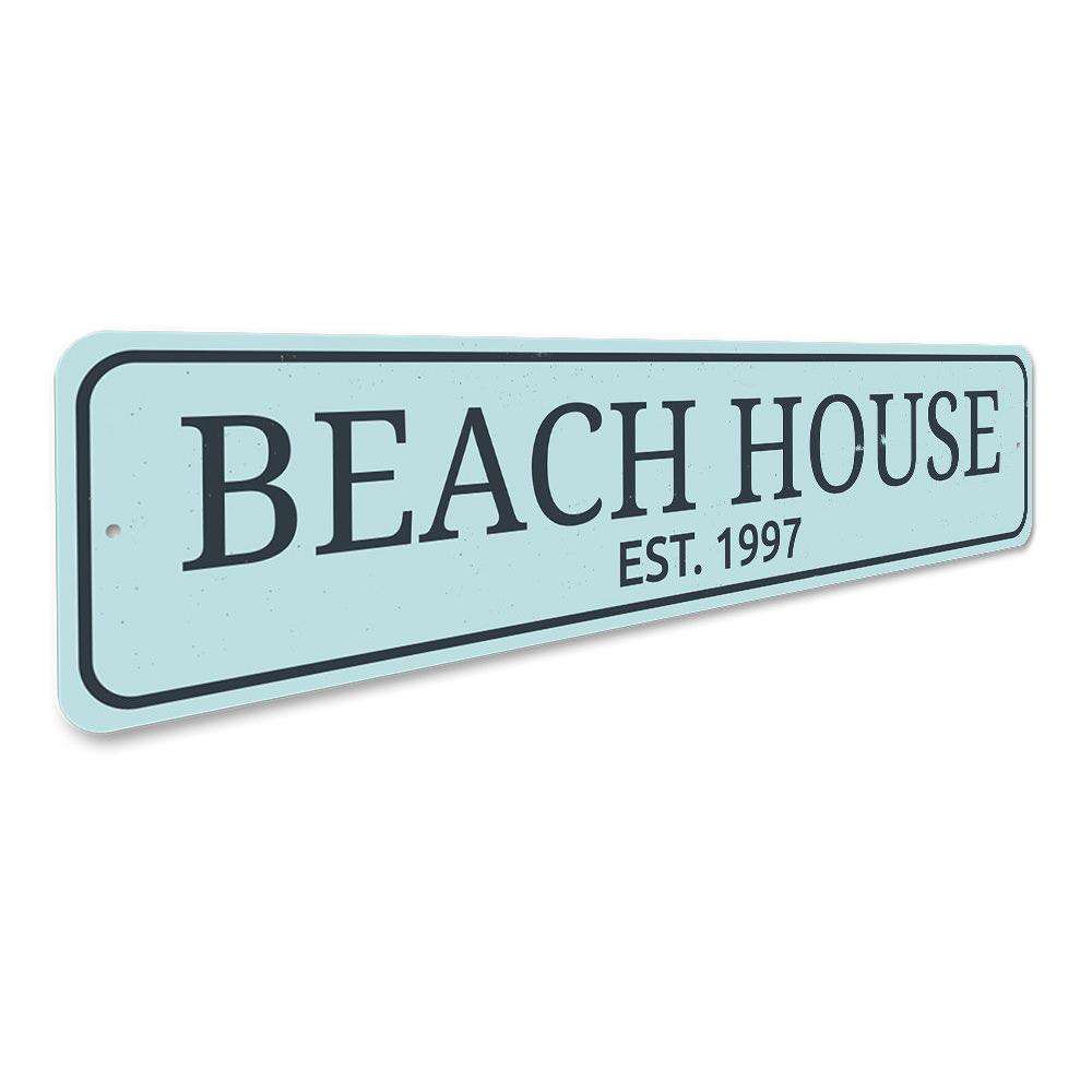 A personalized Beach House Established Date Sign made of high-quality aluminum, featuring custom text and a coastal design, suitable for indoor and outdoor use.