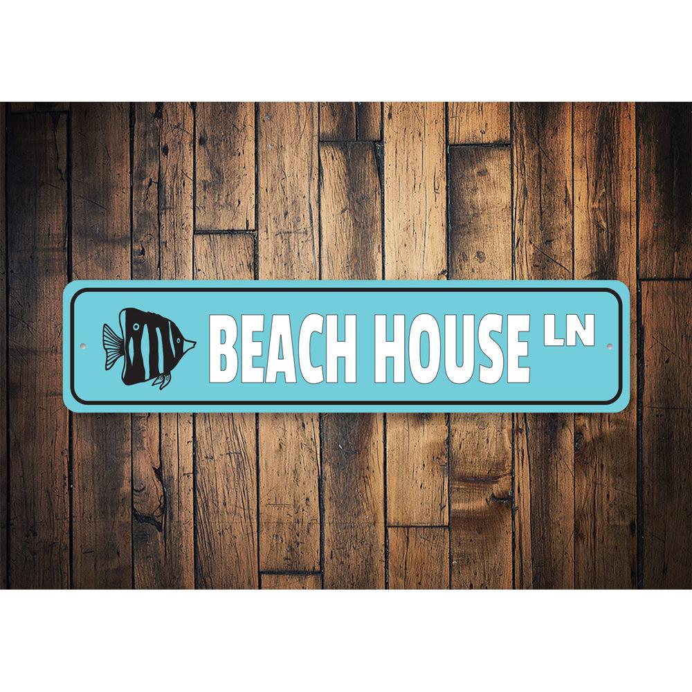 A stylish Beach House Street Sign made of high-quality aluminum, featuring customizable text and pre-drilled holes for easy mounting.