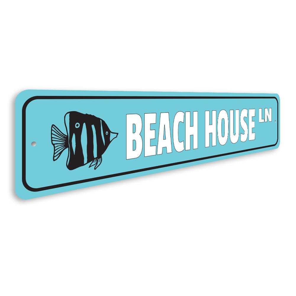 A stylish Beach House Street Sign made of high-quality aluminum, featuring customizable text and pre-drilled holes for easy mounting.