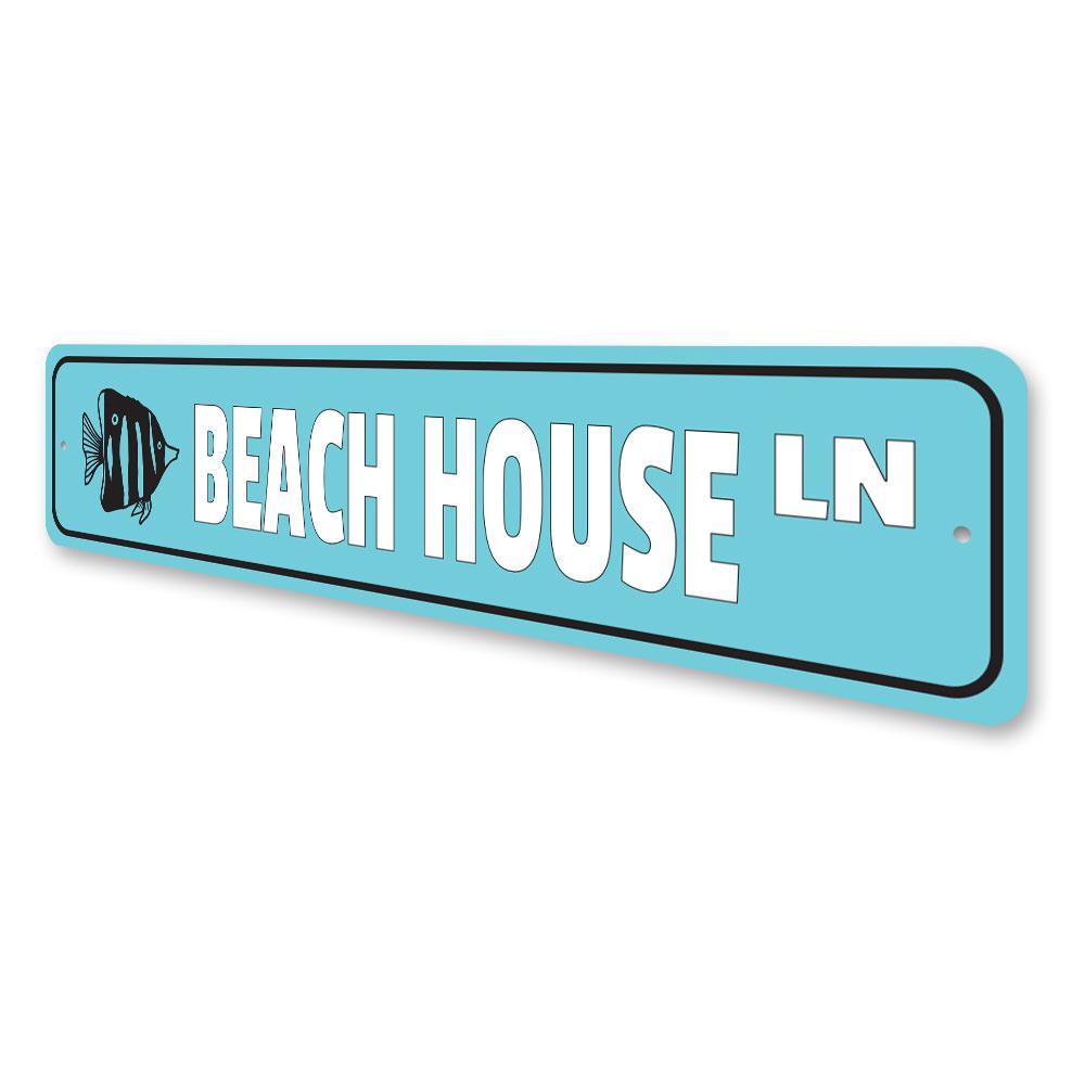 A stylish Beach House Street Sign made of high-quality aluminum, featuring customizable text and pre-drilled holes for easy mounting.