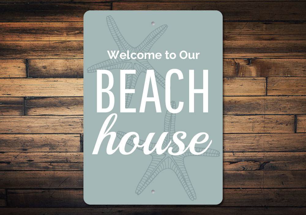 A decorative Beach House Welcome Sign made of high-quality aluminum, featuring customizable text and a coastal design, perfect for beach houses.