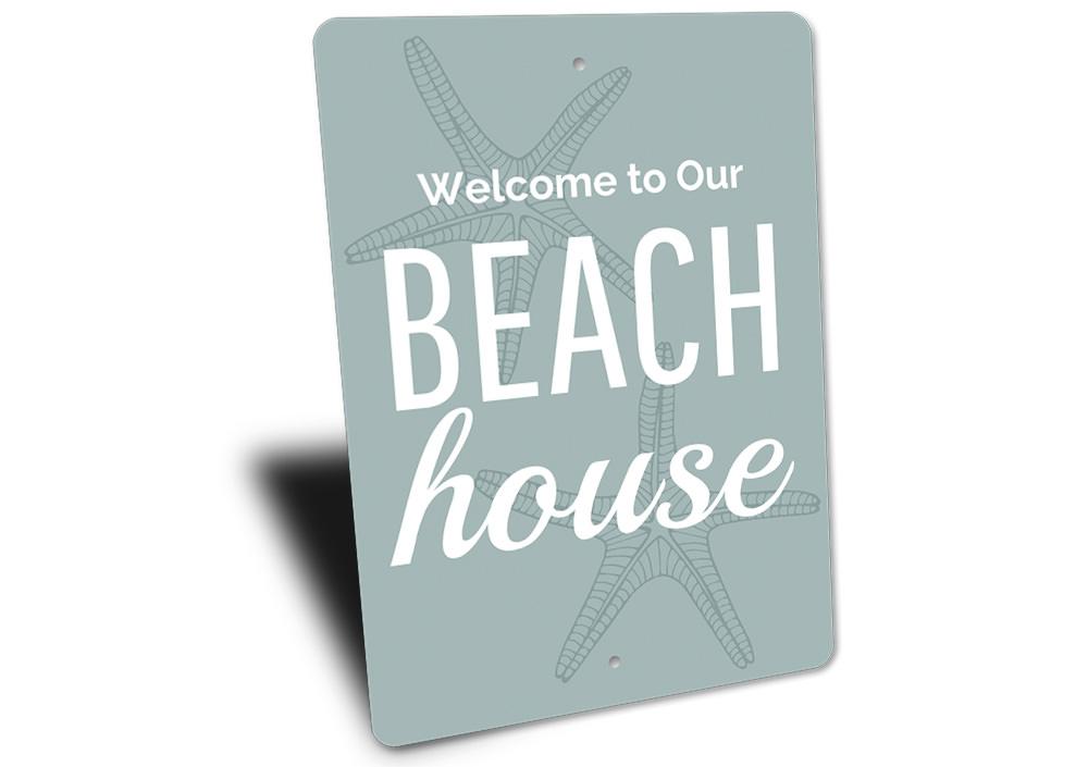 A decorative Beach House Welcome Sign made of high-quality aluminum, featuring customizable text and a coastal design, perfect for beach houses.