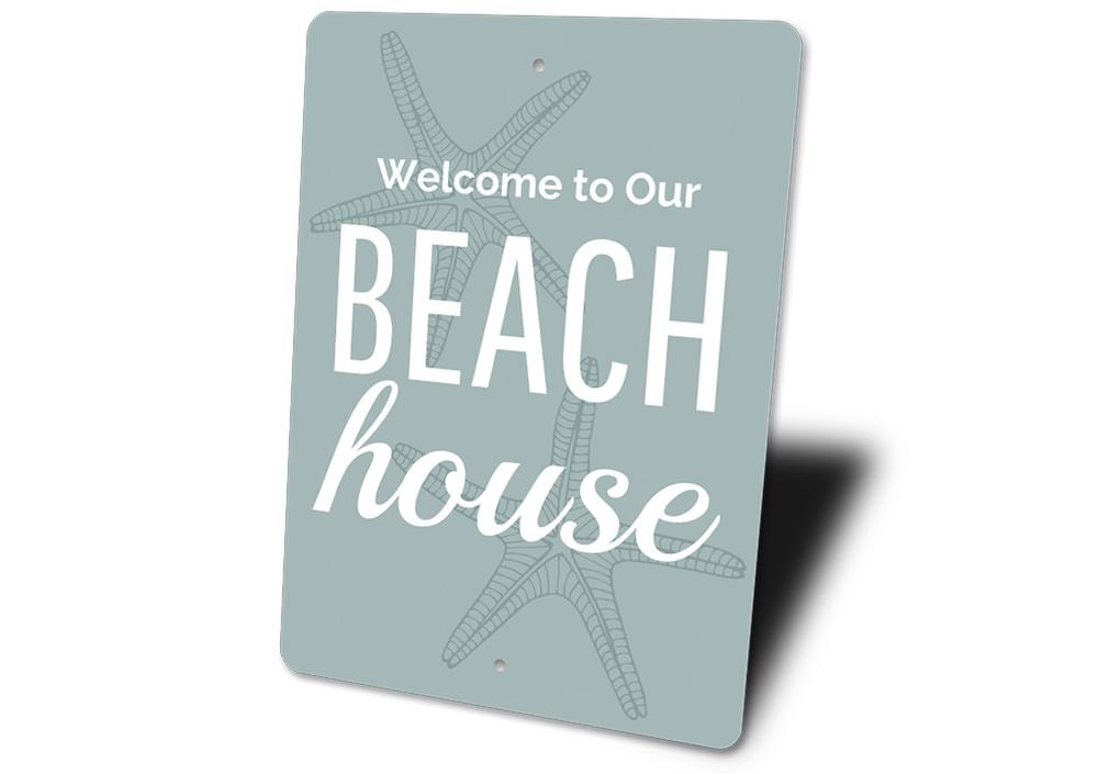 A decorative Beach House Welcome Sign made of high-quality aluminum, featuring customizable text and a coastal design, perfect for beach houses.