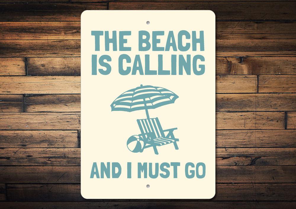 A decorative metal sign reading 'Beach is Calling and I Must Go', featuring a coastal design, perfect for beach houses and outdoor spaces.