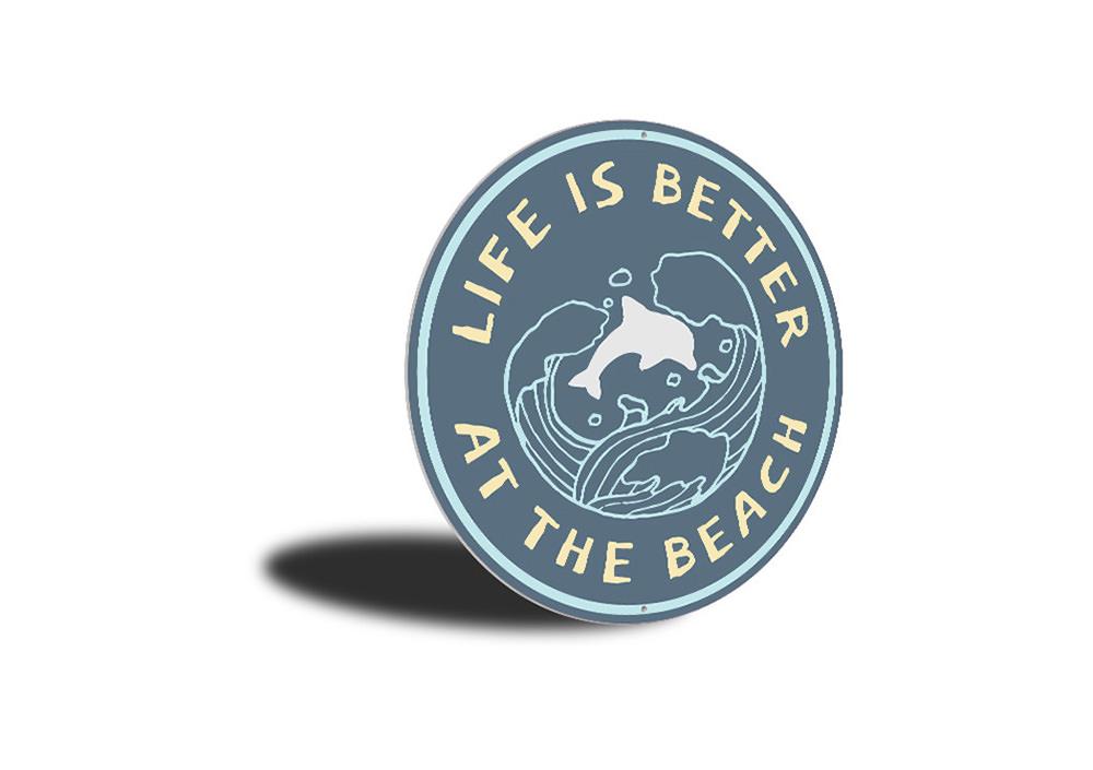 A decorative Beach Life Circle Sign made of aluminum, featuring vibrant colors and beach-themed graphics, perfect for coastal decor.