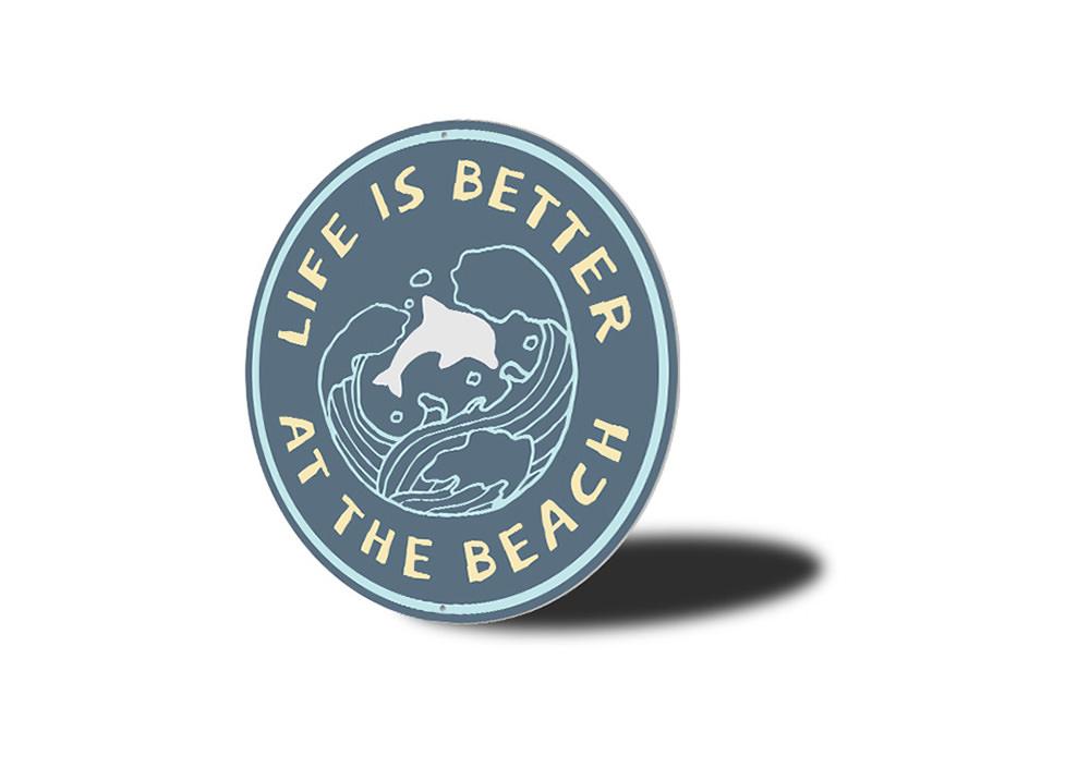 A decorative Beach Life Circle Sign made of aluminum, featuring vibrant colors and beach-themed graphics, perfect for coastal decor.