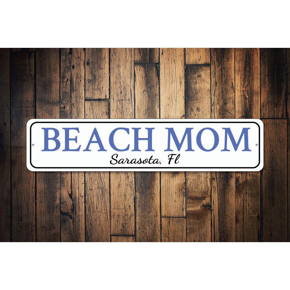 A decorative Beach Mom Sign made of high-quality aluminum, featuring customizable text and pre-drilled holes for easy mounting.