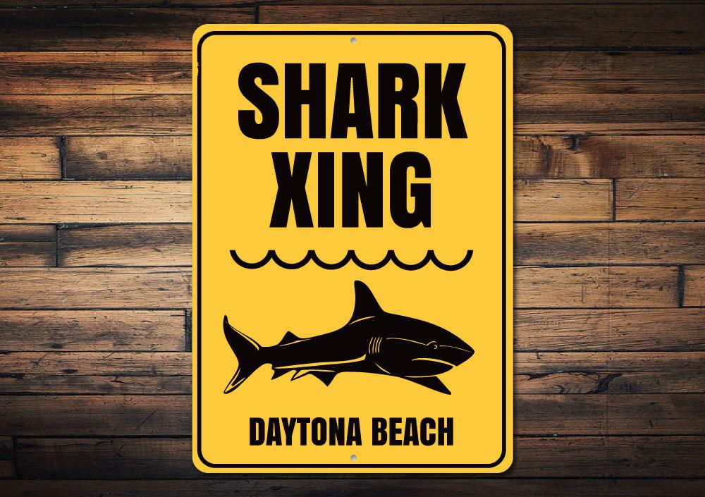 A decorative Beach Name Shark Crossing Sign made of durable aluminum, featuring a vibrant design perfect for coastal decor.